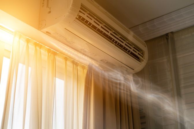 The old, dusty air conditioner in the room is not functioning properly. The old, dusty air conditioner in the room is not functioning properly.