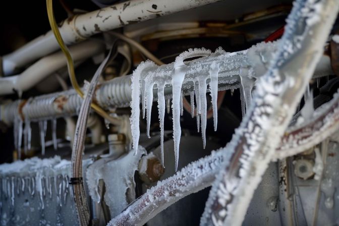 Close-up photo of frozen evaporator coils with low gas levels. Close-up photo of frozen evaporator coils with low gas levels.