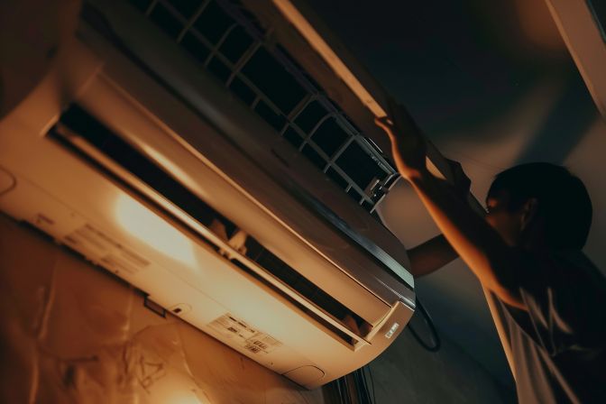 A professional technician correctly installs a level air conditioner to prevent leaks. A professional technician correctly installs a level air conditioner to prevent leaks.