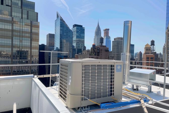 The well-maintained air conditioning unit on a city rooftop. The well-maintained air conditioning unit on a city rooftop.