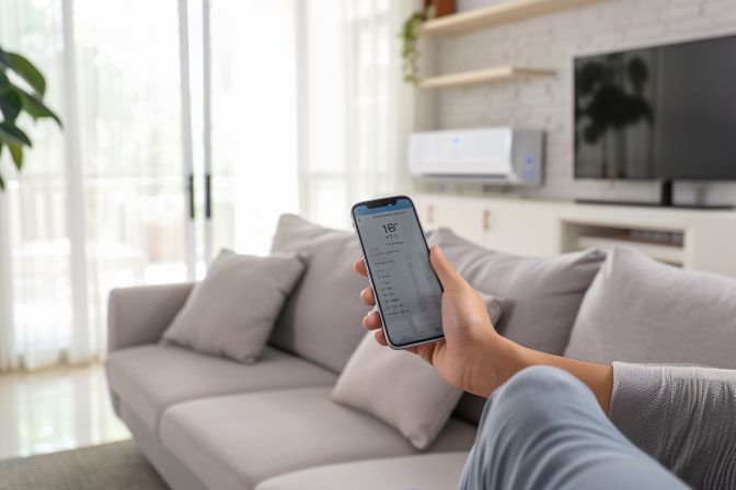 A modern air conditioning unit with advanced features in a living room. A modern air conditioning unit with advanced features in a living room.