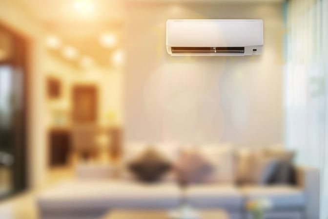 A well-maintained air conditioning unit in a residential living room. A well-maintained air conditioning unit in a residential living room.